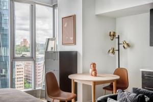a living room with a table and chairs and a window at Pioneer Square studio w gym bbq nr stadium SEA-586 in Seattle