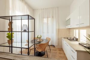 a kitchen with a glass table and a sink at City port Apartment in Herceg-Novi