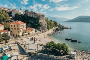 a view of a beach next to a body of water at City port Apartment in Herceg-Novi