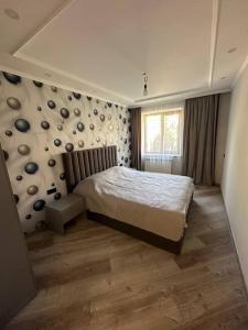a bedroom with a bed and a wall with plates at ZAK Home in Gyumri