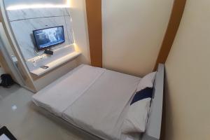 a hospital room with a bed and a television at OYO Life 92812 Galih Kostel 2 Syariah in Grobogan