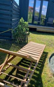 a wooden picnic table in front of a house at MMA apartament in Klaipėda