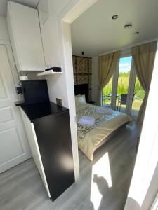 a small bedroom with a bed and a mirror at MMA apartament in Klaipėda