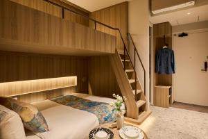 a bedroom with a bunk bed and a staircase at FAV TOKYO Ryogoku in Tokyo