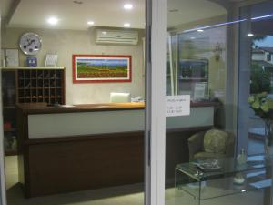 a shop with a reception desk and a chair at Residence La Margherita in Lazise