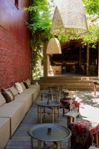 a patio with couches and tables and a building at Life Gallery Hotel in Korçë