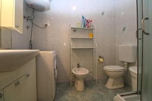 a small bathroom with a toilet and a sink at Apartment Stinjan 2287 in Pula