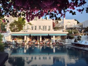 a hotel with a pool in front of a building at Belvedere Mykonos - Main Hotel - The Leading Hotels of the World in Mikonos
