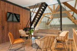 a living room with a couch and chairs at Hoeve-C in Ieper