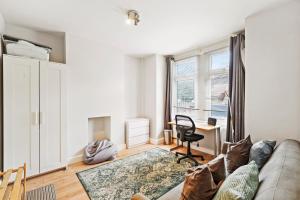 a living room with a couch and a desk at Livestay-Three Bedroom House in Belvedere with Private Garden in Belvedere