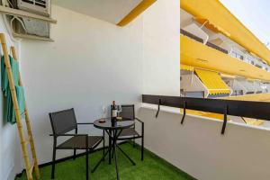 a room with a table and chairs and a bunk bed at Dunas House Playa del Inglés in San Bartolomé