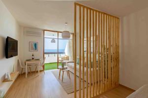 a living room with a room with a table and a desk at Dunas House Playa del Inglés in San Bartolomé