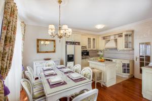 a dining room and kitchen with a table and chairs at Villa Sea Breeze in Split