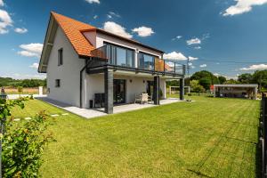 a house with an orange roof and a yard at Lamelove Apartments in Chocznia