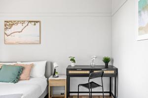 a desk in a bedroom with a bed and a chair at Comfort Queen Room - Private - Prime Spot in Sydney