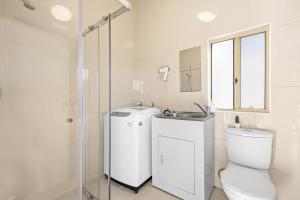 a bathroom with a toilet and a sink and a shower at Comfort Queen Room - Private - Prime Spot in Sydney
