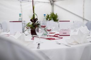 a white table with wine glasses on it at Landgasthof Birkel in Herrieden