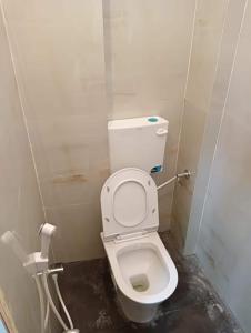 a bathroom with a white toilet in a stall at OYO Hotel Orvin In in Jabalpur