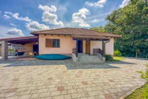 a house with a patio in front of it at Wellness House On The River Kupa - Happy Rentals in Banska Selnica