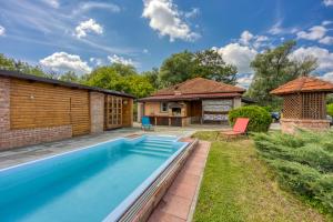 a backyard with a swimming pool and a house at Wellness House On The River Kupa - Happy Rentals in Banska Selnica