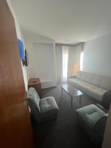 a living room with a couch and a table at Hotel Banat in Olimp