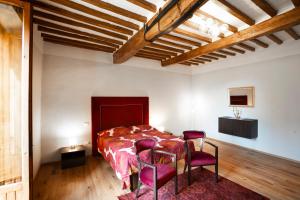 Un pat sau paturi într-o cameră la Palazzo Galganetti Betti