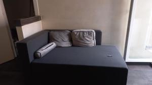 a black couch with two pillows on top of it at Palms House in Rome