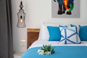 a bedroom with a blue bed with a flower on it at Zog Villas in Koh Samui 