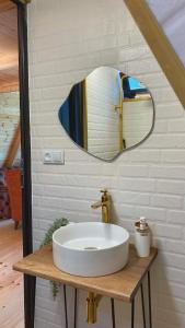 a bathroom with a sink and a mirror at Sun House in Batumi