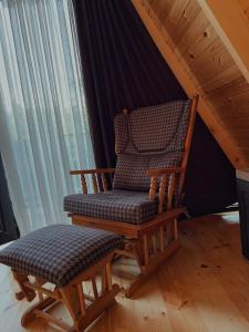 a rocking chair and a bench in a attic at Sun House in Batumi