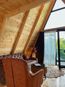 a living room with a couch and a large window at Sun House in Batumi