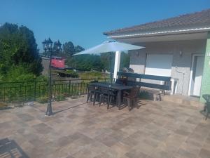 un patio con mesa y sombrilla en Casa Antonio, en Porriño
