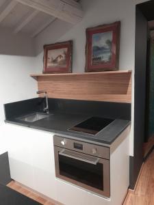 a kitchen with a sink and a stove at Hotel Priori Secret Garden in Perugia