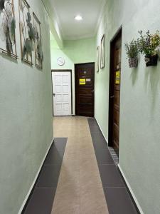 a hallway with two doors and a tile floor at Perhentian Mama's in Perhentian Islands