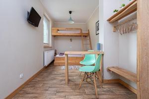 Cette chambre comprend un bureau et des lits superposés. dans l'établissement Apartamenty Kaszuby, à Szymbark
