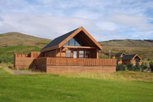 a wooden house in the middle of a field at Gljúfurbústaðir Holiday Homes in Hveragerði