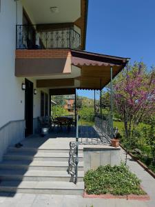 a house with a balcony and stairs with a table at TRABZON VILLA l in Trabzon