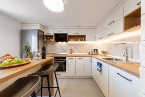a kitchen with white cabinets and a counter top at Villa Spalato in Split