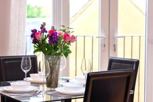 a table with a vase of flowers on it at Brand new Apartment by the Marina - Sleeps 4 in Ramsgate