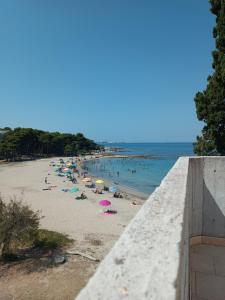 a beach with a bunch of people in the water at Appartamenti La Spiaggia in Gallipoli