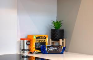 a shelf with snacks and a potted plant on it at Brand new Apartment by the Marina - Sleeps 4 in Ramsgate