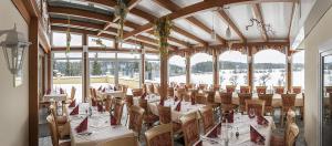 a dining room with tables and chairs and windows at Landgasthof - Café Anni in Birgland