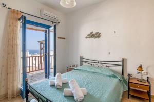 a bedroom with a bed and a balcony at Lovely Apartment With Shared Pool in Aspro Chorio Paros +16 photos