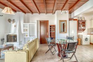 a living room with a couch and a glass table at Lovely Apartment With Shared Pool in Aspro Chorio Paros