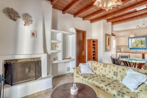 a living room with a couch and a fireplace at Lovely Apartment With Shared Pool in Aspro Chorio Paros