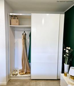 a dressing room with a closet with a robe in it at Apartments Sinković in Dubrovnik