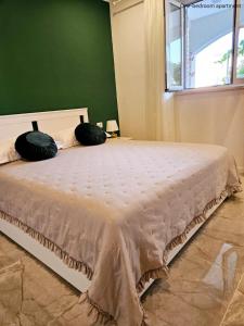 a bedroom with a bed with two pillows on it at Apartments Sinković in Dubrovnik