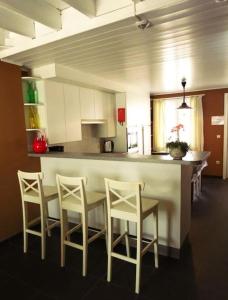 a kitchen with a table and chairs and a counter at Hof ter Harte in Ieper +21 photos