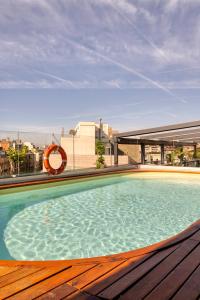 a swimming pool on the roof of a building at Hotel America Barcelona in Barcelona