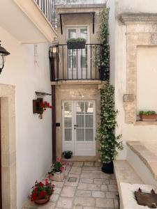a front door of a house with flowers and plants at La Gnostretta in Noci
